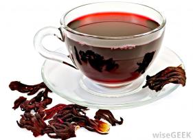 cup-of-hibiscus-tea-surrounded-by-dried-petals